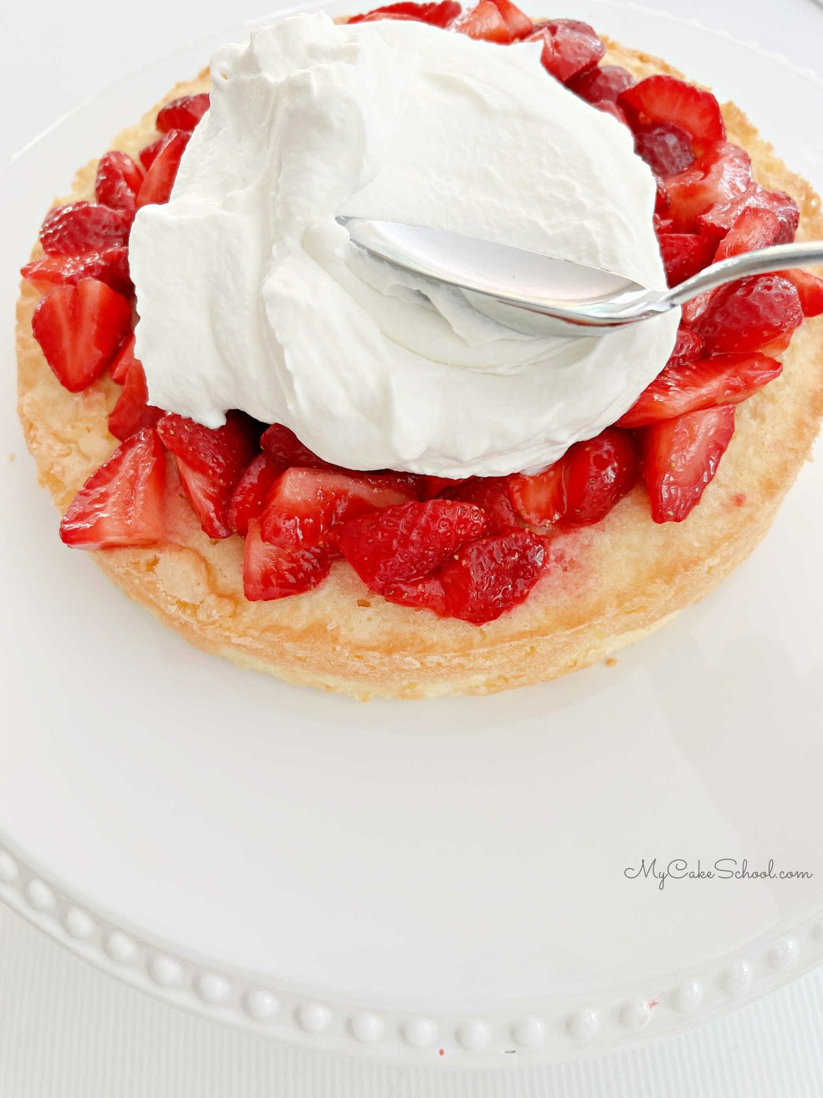 Spreading strawberries with whipped cream