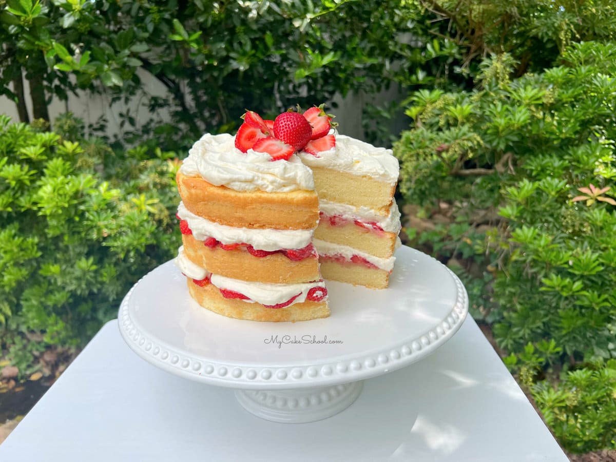 Sliced Strawberry Shortcake on white pedestal