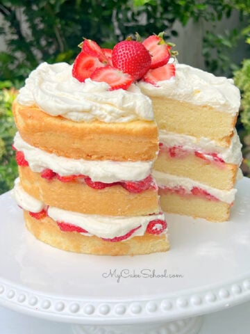 Strawberry Shortcake Cake on a white pedestal