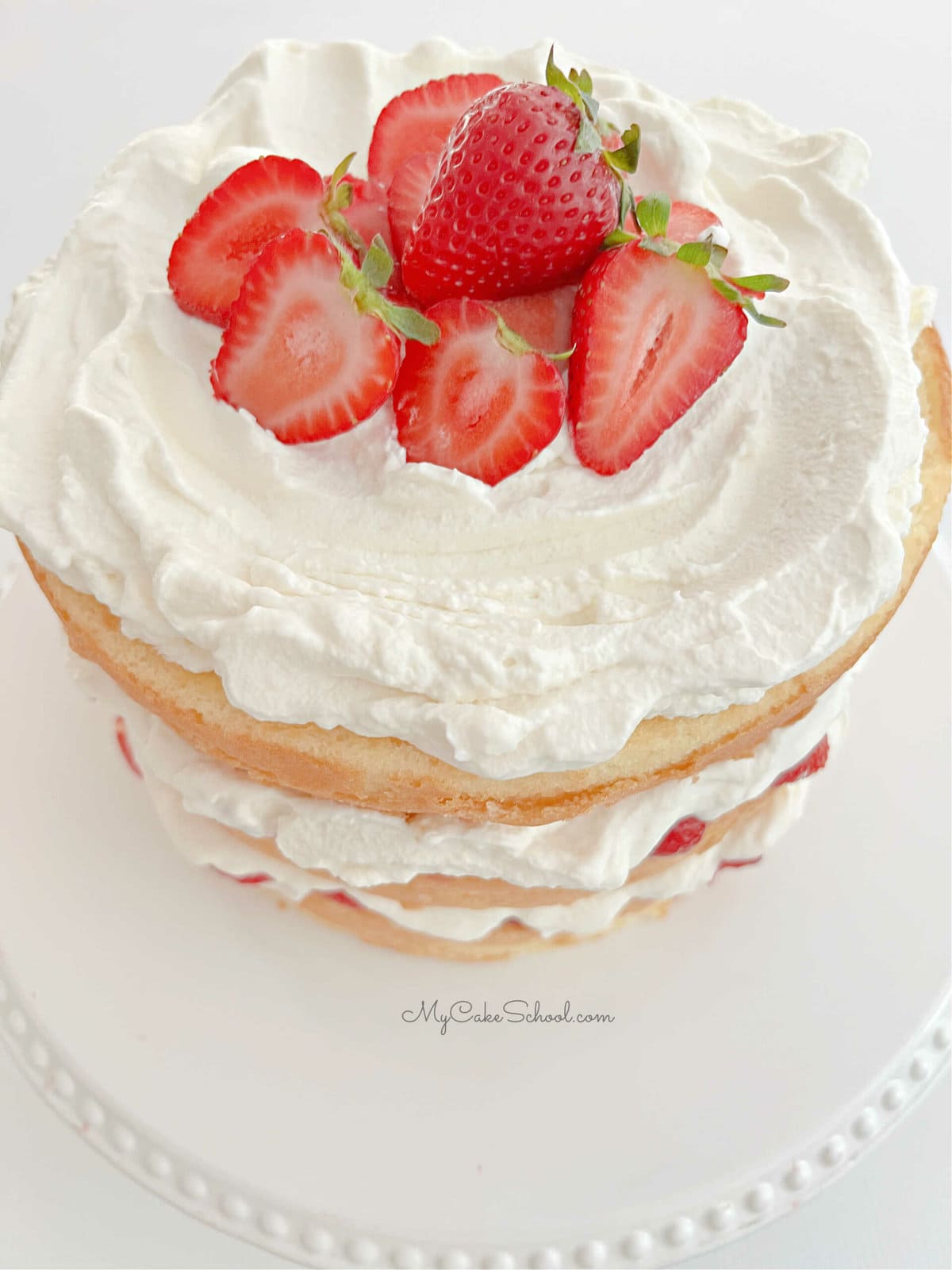 Top view of strawberry shortcake, topped with fresh strawberries