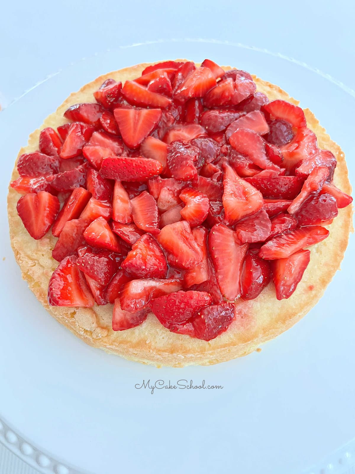 Pound cake layer topped with sliced strawberries