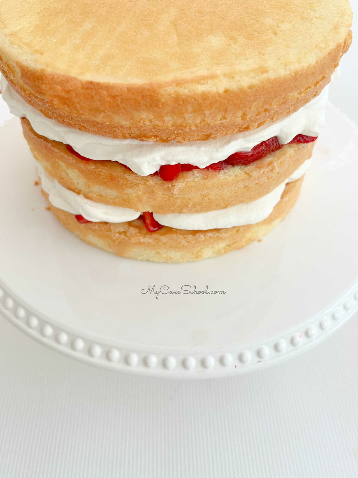 Layered Strawberry Shortcake with pound cake, berries, and whipped cream