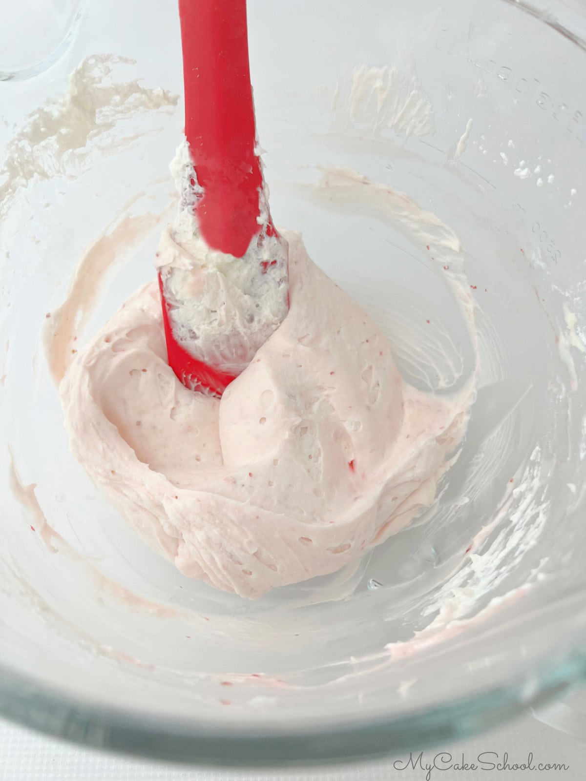 Strawberry Whipped Cream Cheese Frosting, in bowl with spatula