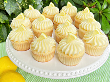 Lemon Cupcakes with Lemon Cream Cheese Frosting on white pedestal