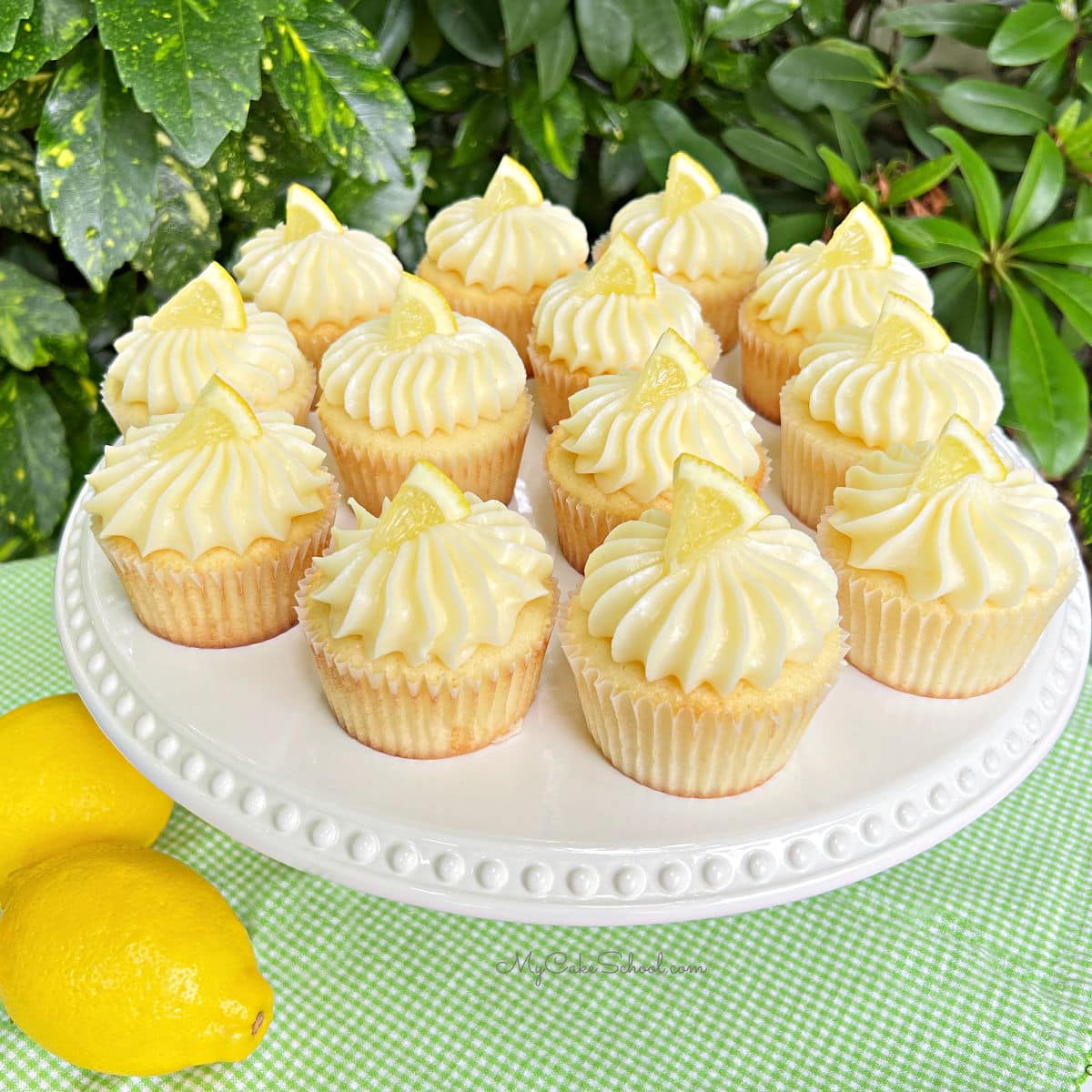 Lemon Cupcakes with Lemon Cream Cheese Frosting on white pedestal
