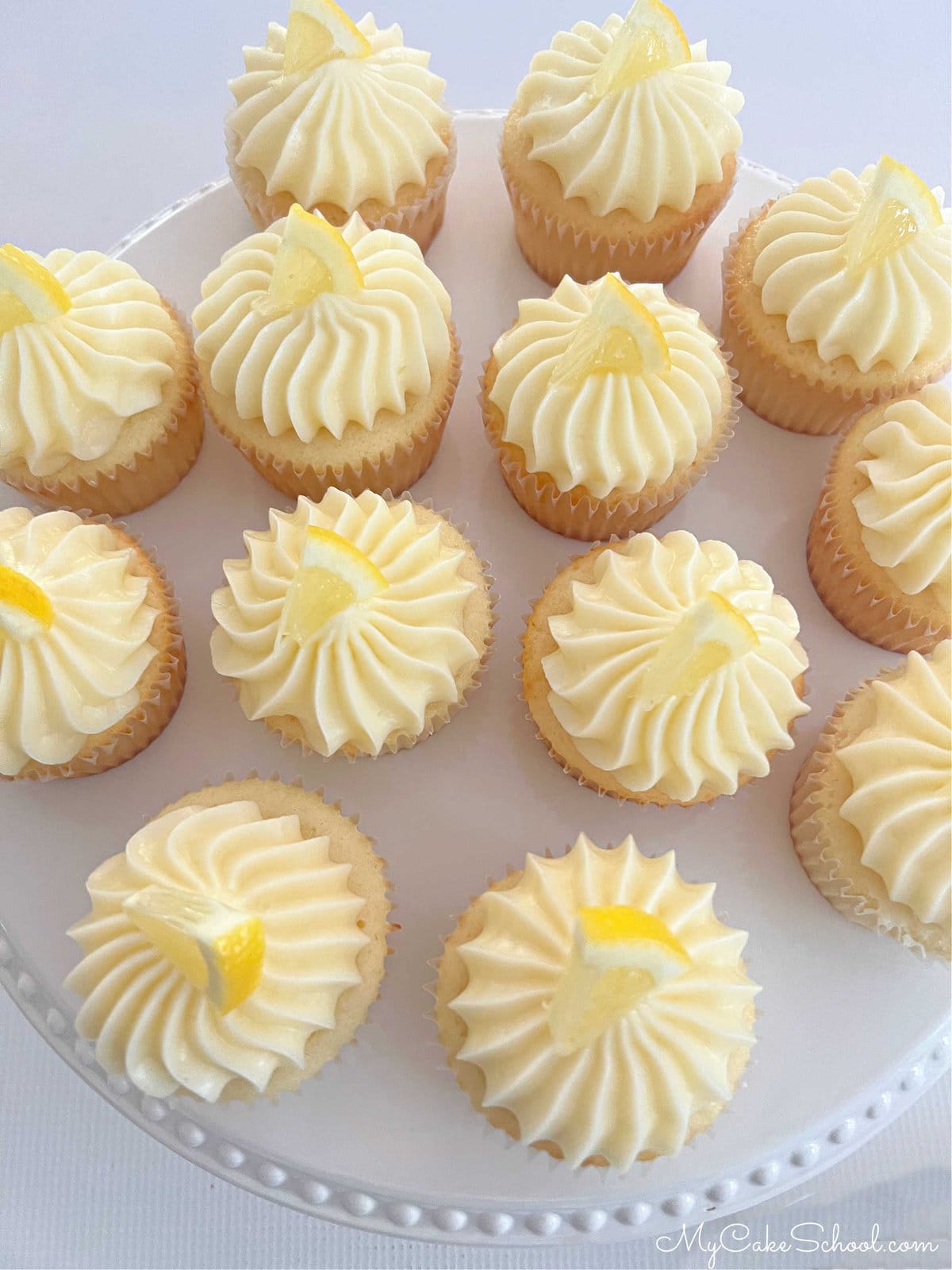 Overhead view of Lemon Cupcakes with Lemon Frosting, topped with lemon slices