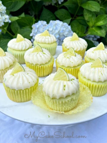Margarita Cupcakes on white pedestal, against background of hyndrangeas.