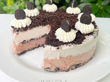 Oreo Ice Cream Cake, sliced, on a white platter
