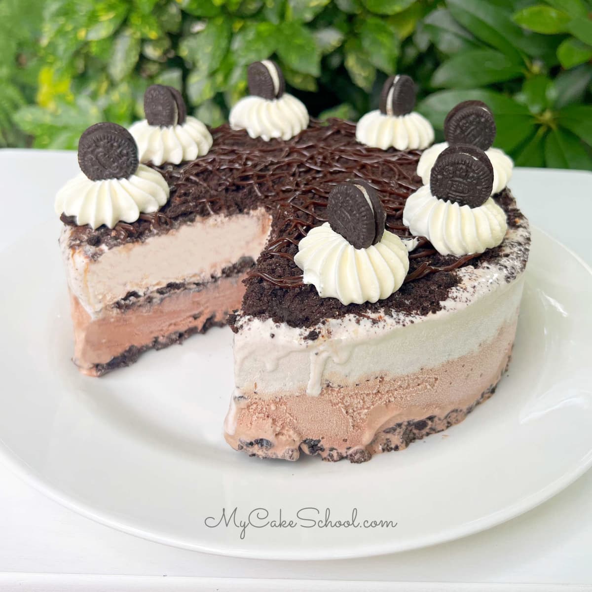 Oreo Ice Cream Cake, sliced, on a white platter