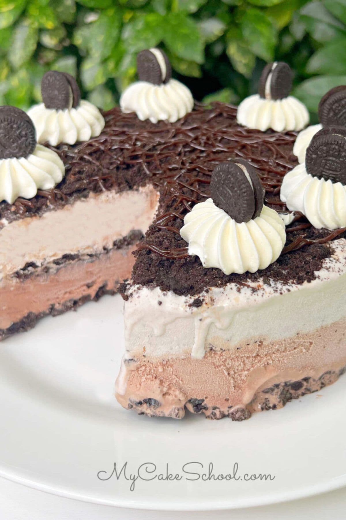 Oreo Ice Cream Cake, sliced, on a pedestal.