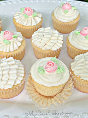 Platter of Vanilla Cupcakes, decorated with buttercream ruffles and roses.