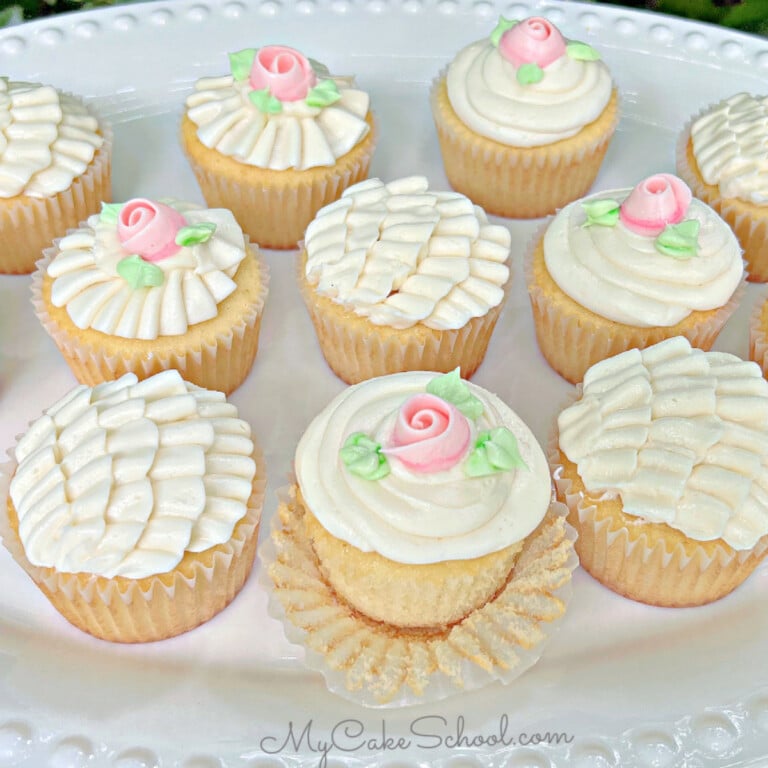 Platter of Vanilla Cupcakes, decorated with buttercream ruffles and roses.