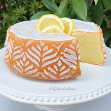 Sliced Lemon Pound Cake on a white pedestal.