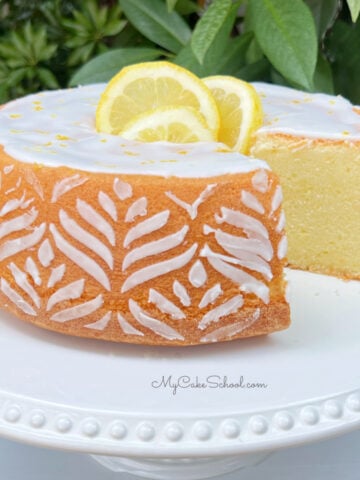 Sliced Lemon Pound Cake on a white pedestal.