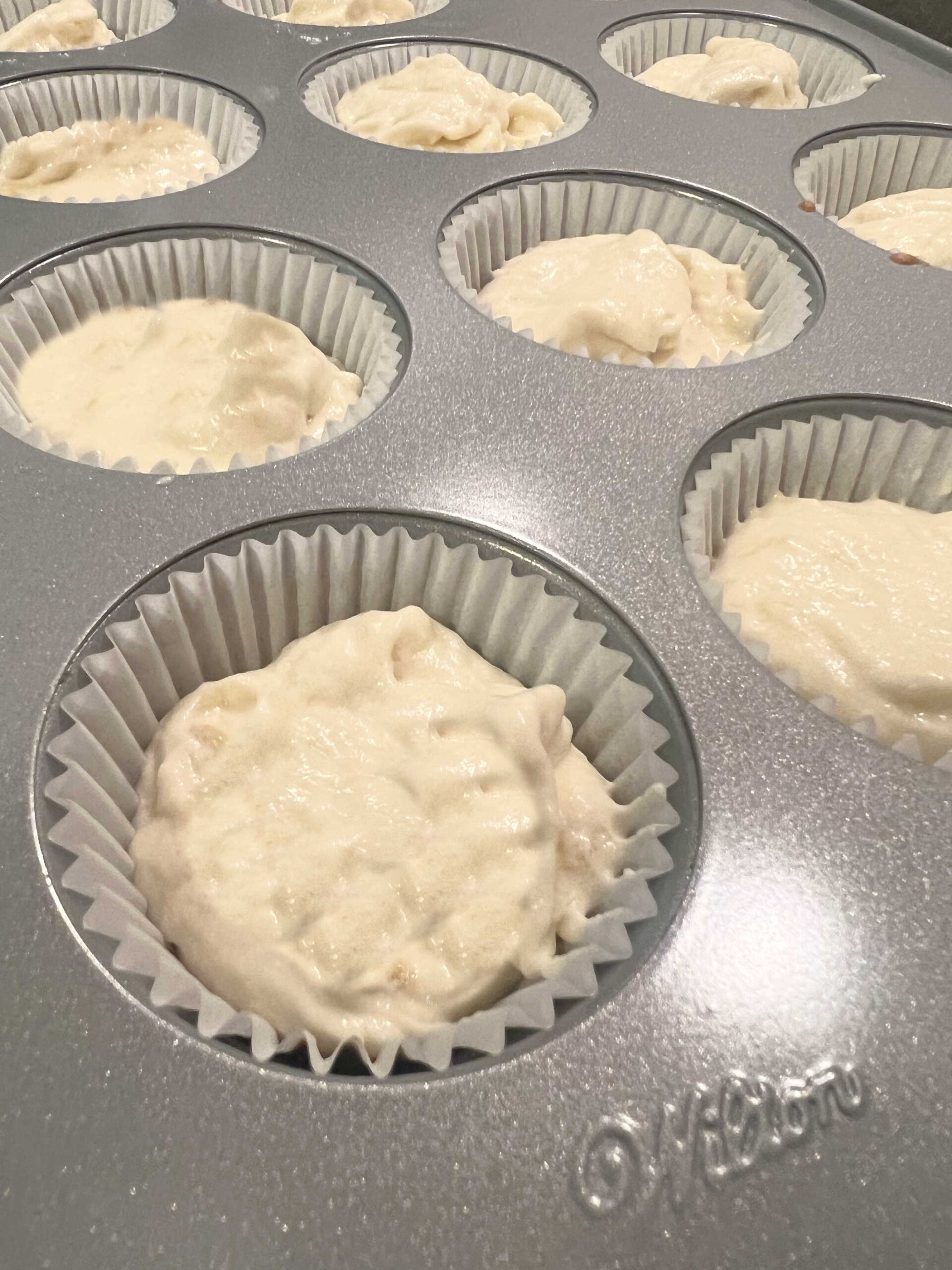 Banana cupcake batter in cupcake pans.