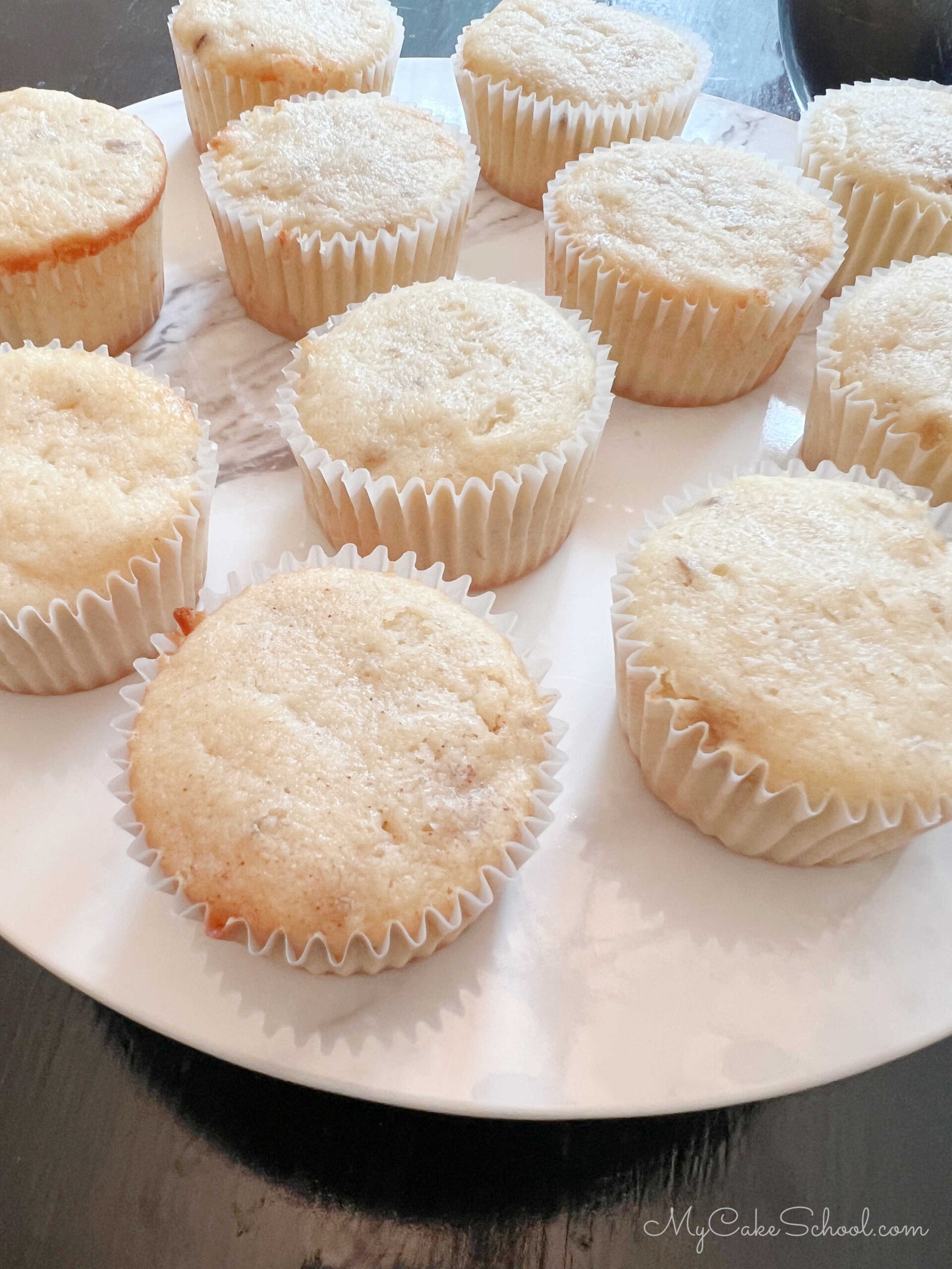 Banana Cupcakes on cake pedestal, unfrosted.