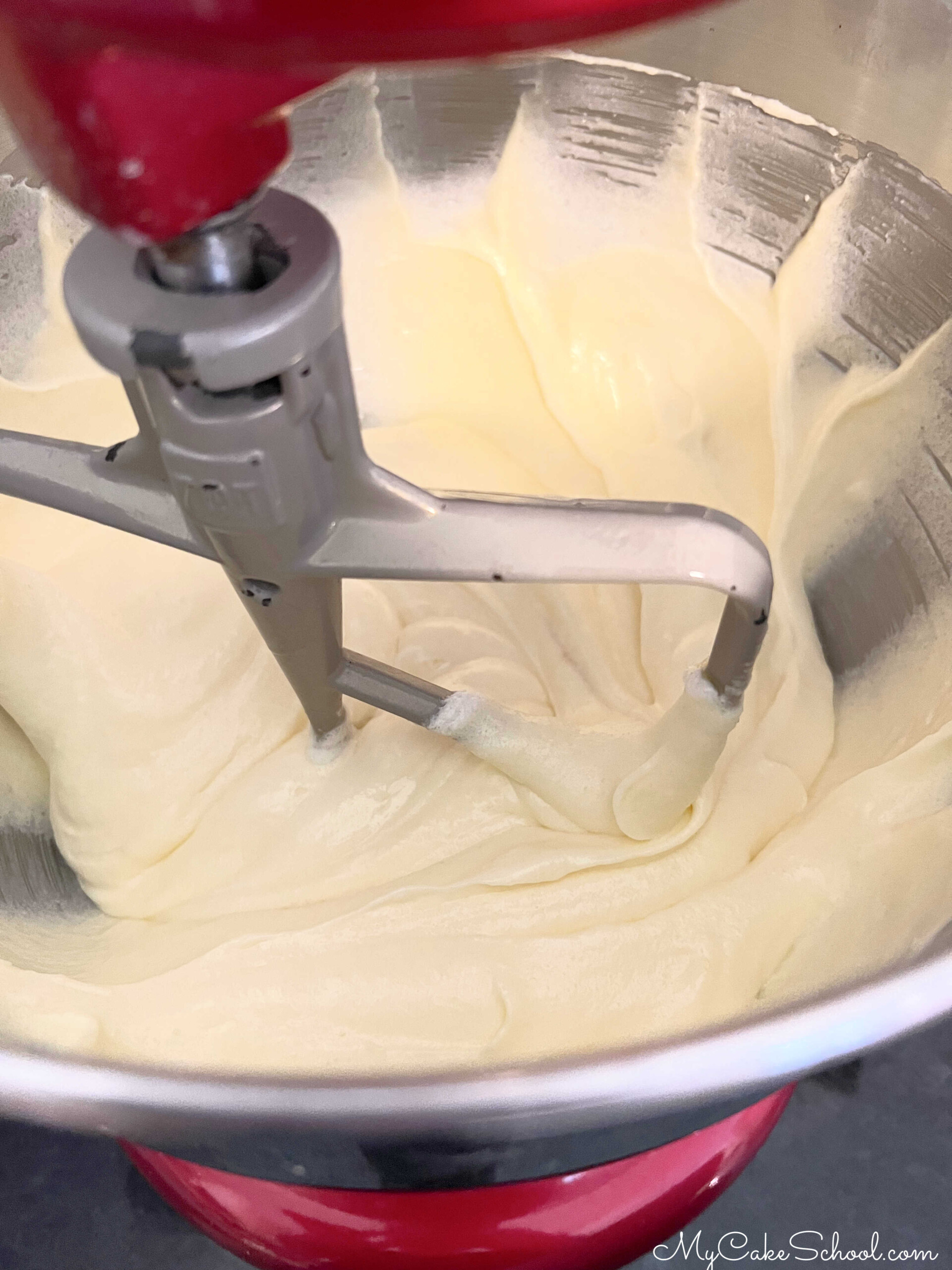 Adding eggs to pound cake batter.