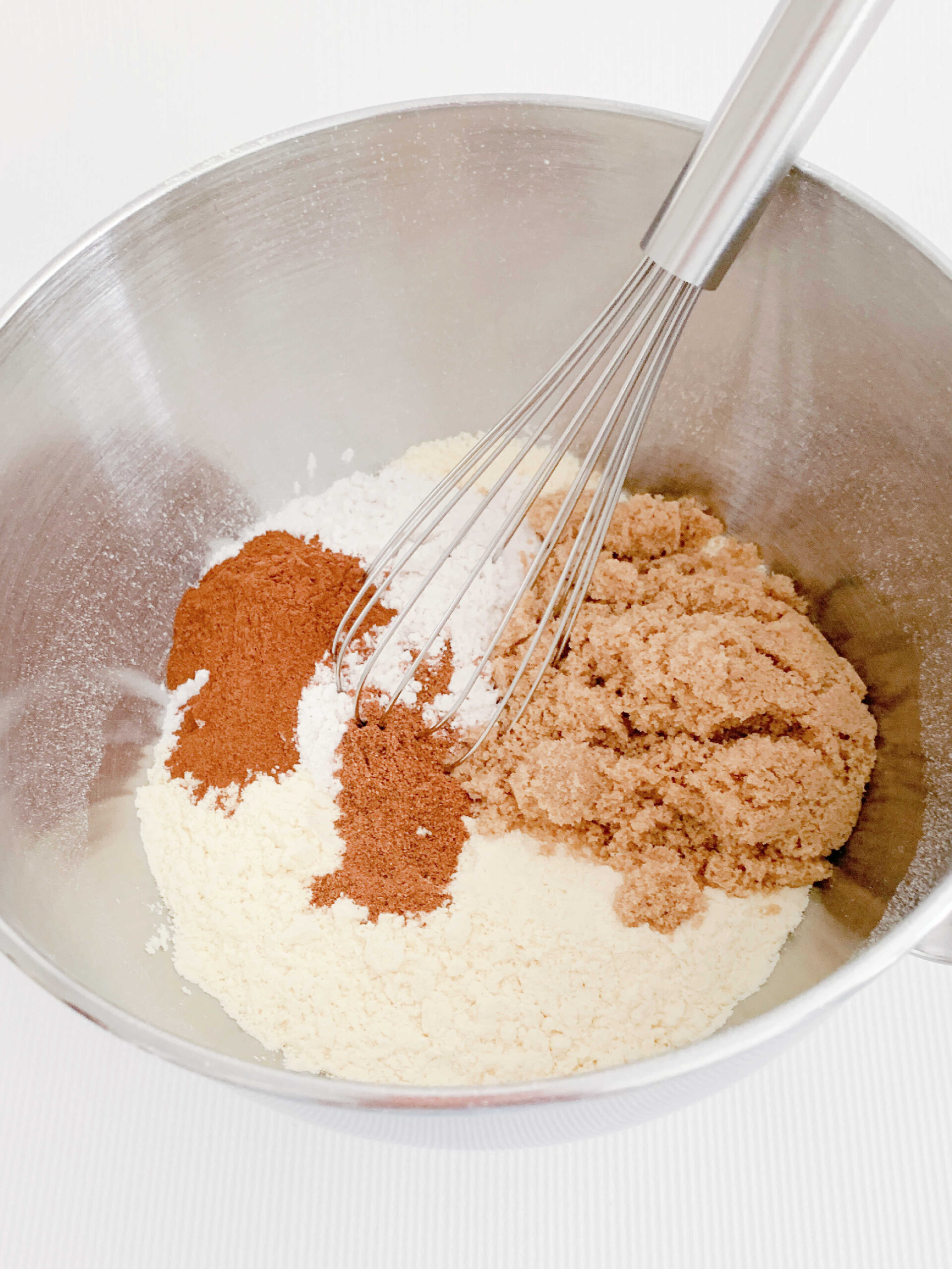 Dry ingredients in mixing bowl for apple bundt cake.