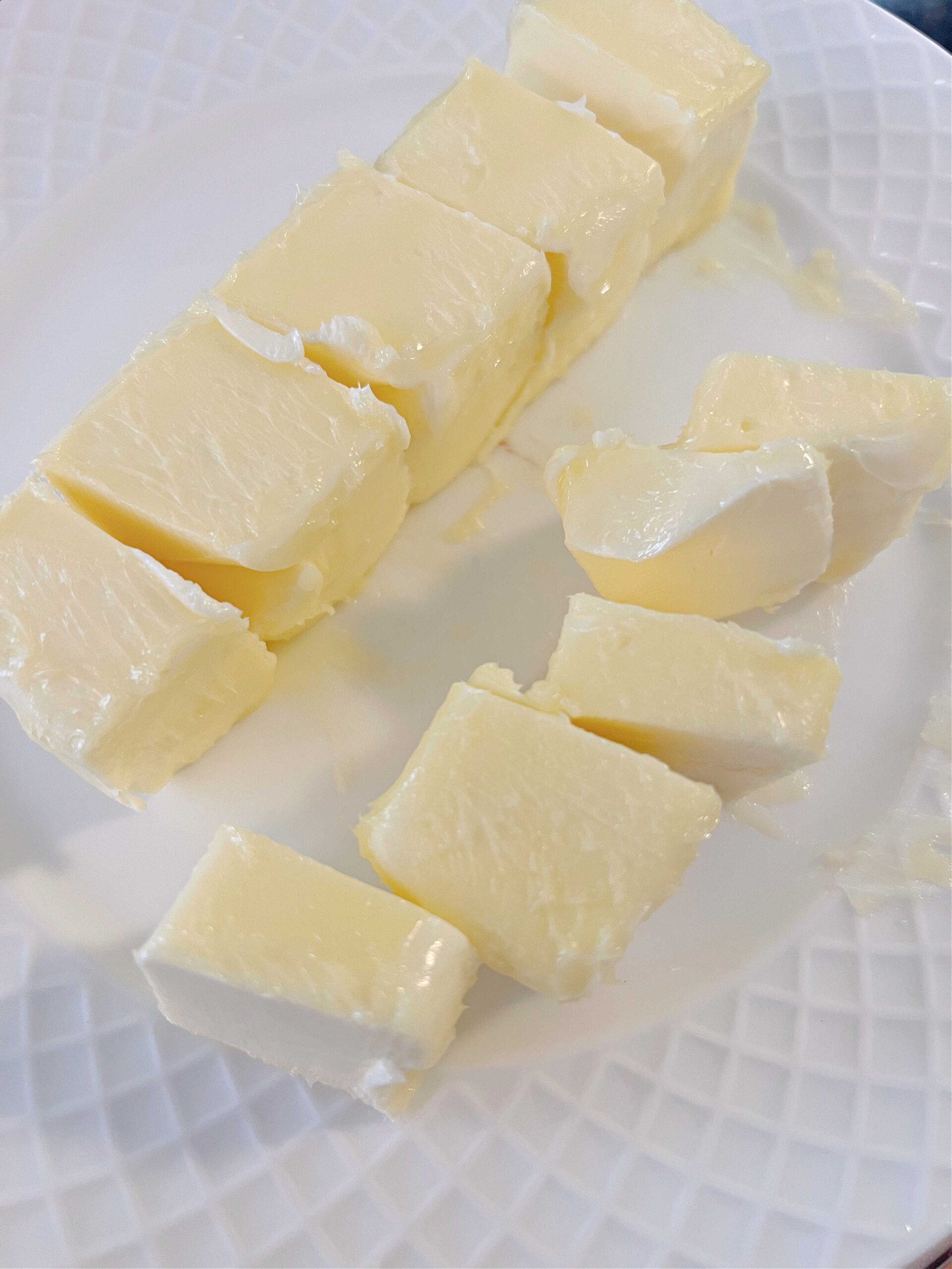 Slightly softened butter on a white plate.