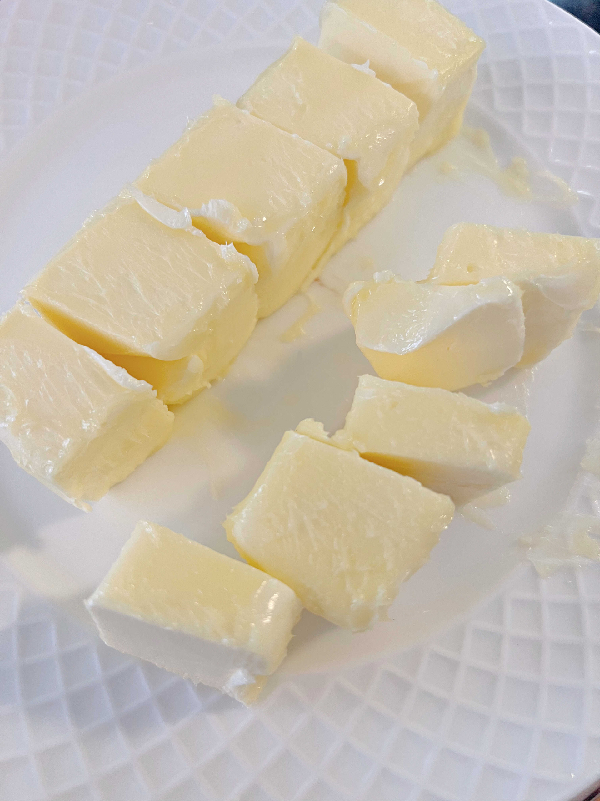 Slightly softened butter on a white plate.