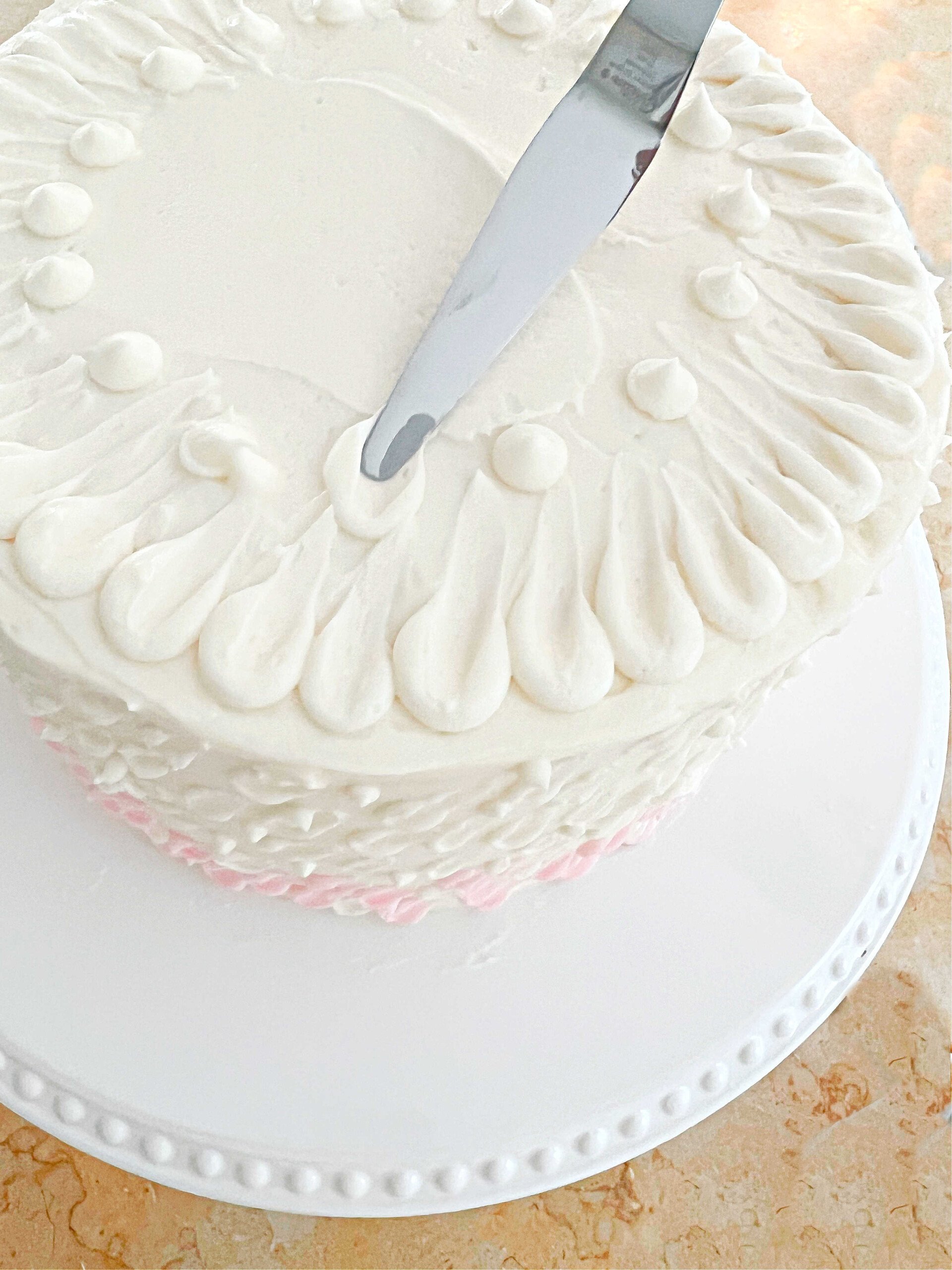 Decorating the Pink Velvet Cake.
