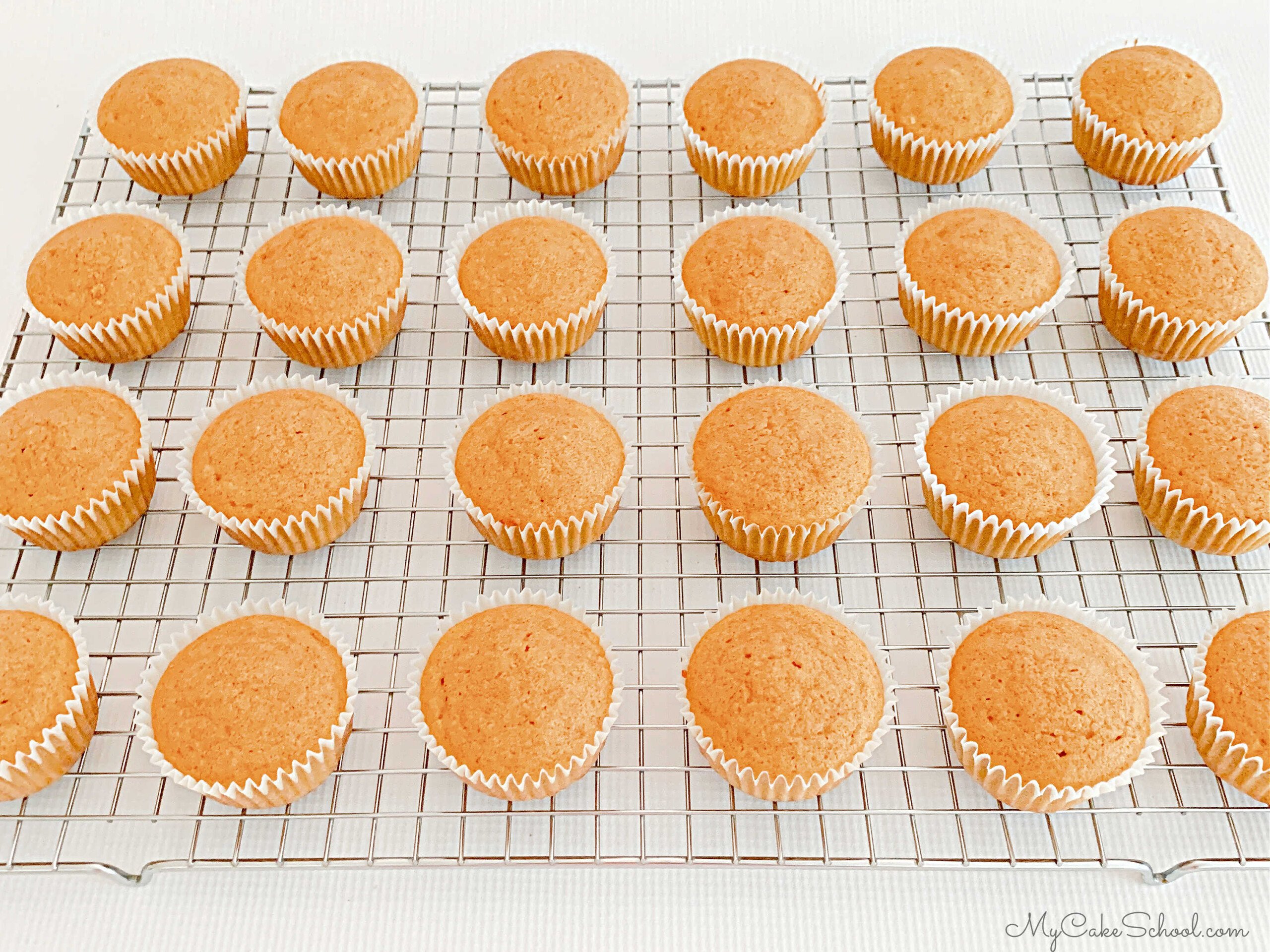 Pumpkin Cupcakes cooling on a wire rack.