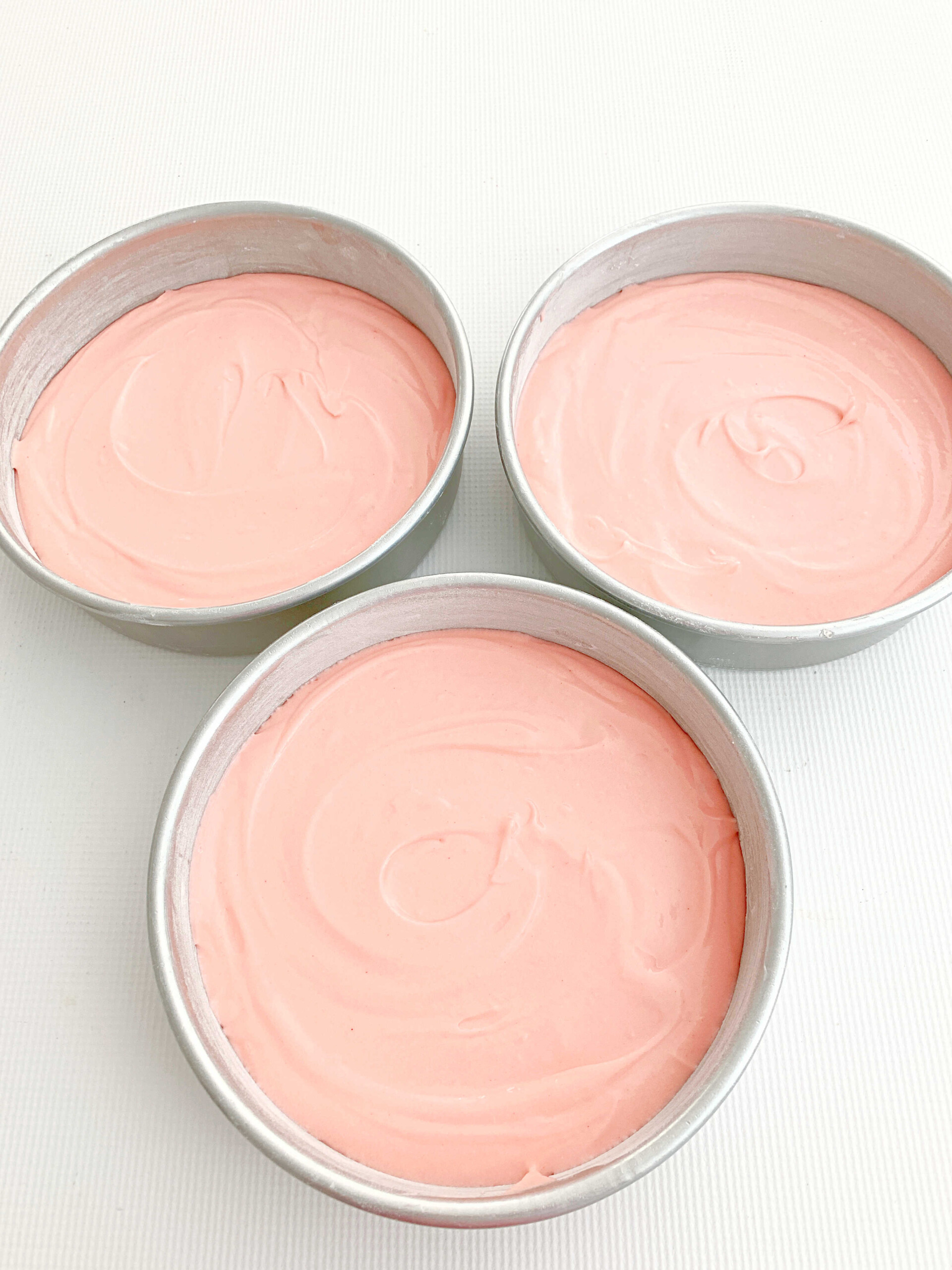 Pink Velvet Cake Batter in three pans.