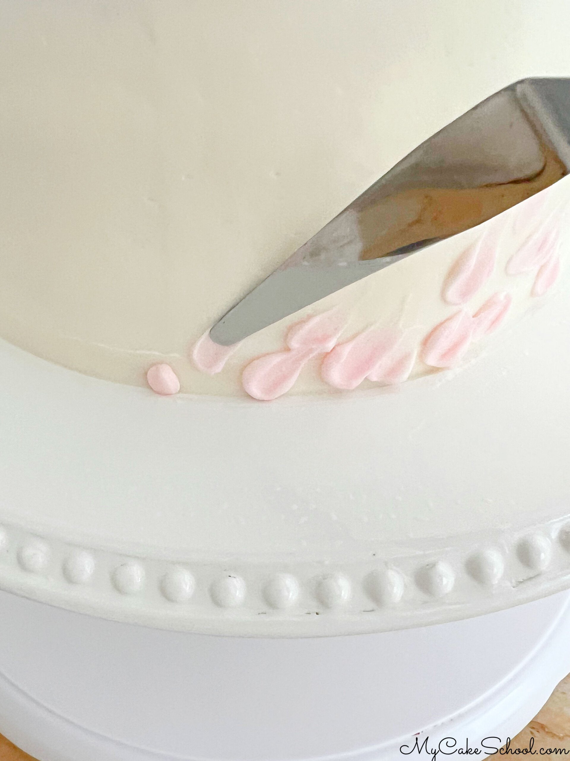 Adding texture to the frosted cake.