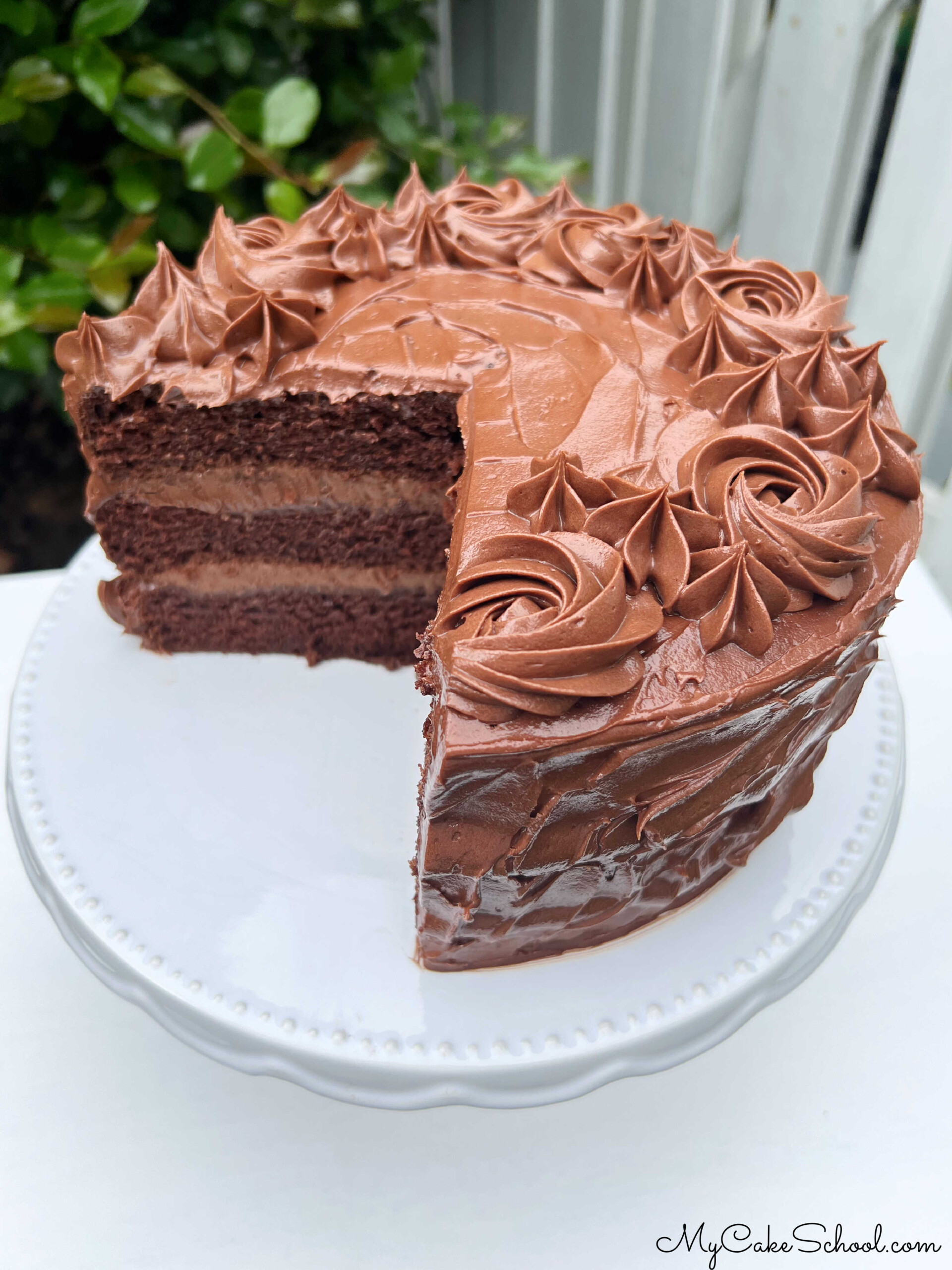 Chocolate Mousse Cake, sliced, on a pedestal.