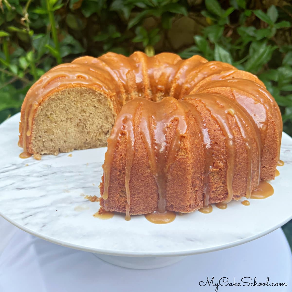 Banana Pound Cake, sliced, on a pedestal.