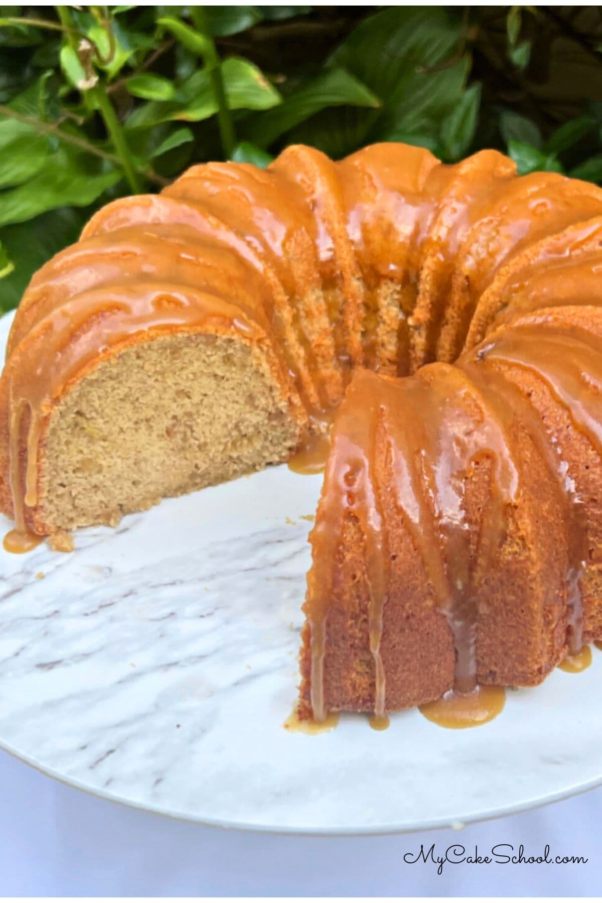 Sliced banana pound cake on a pedestal.