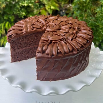 Brownie Cake, sliced, on a cake pedestal.