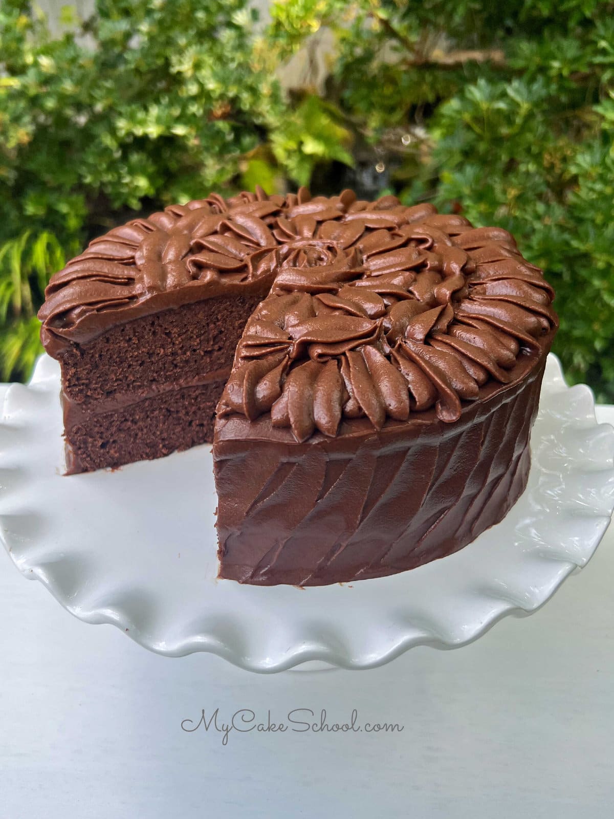Brownie Cake, sliced, on a cake pedestal.