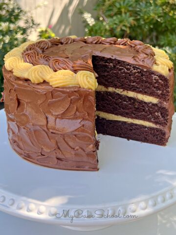 Sliced Chocolate Caramel Cake on a pedestal.