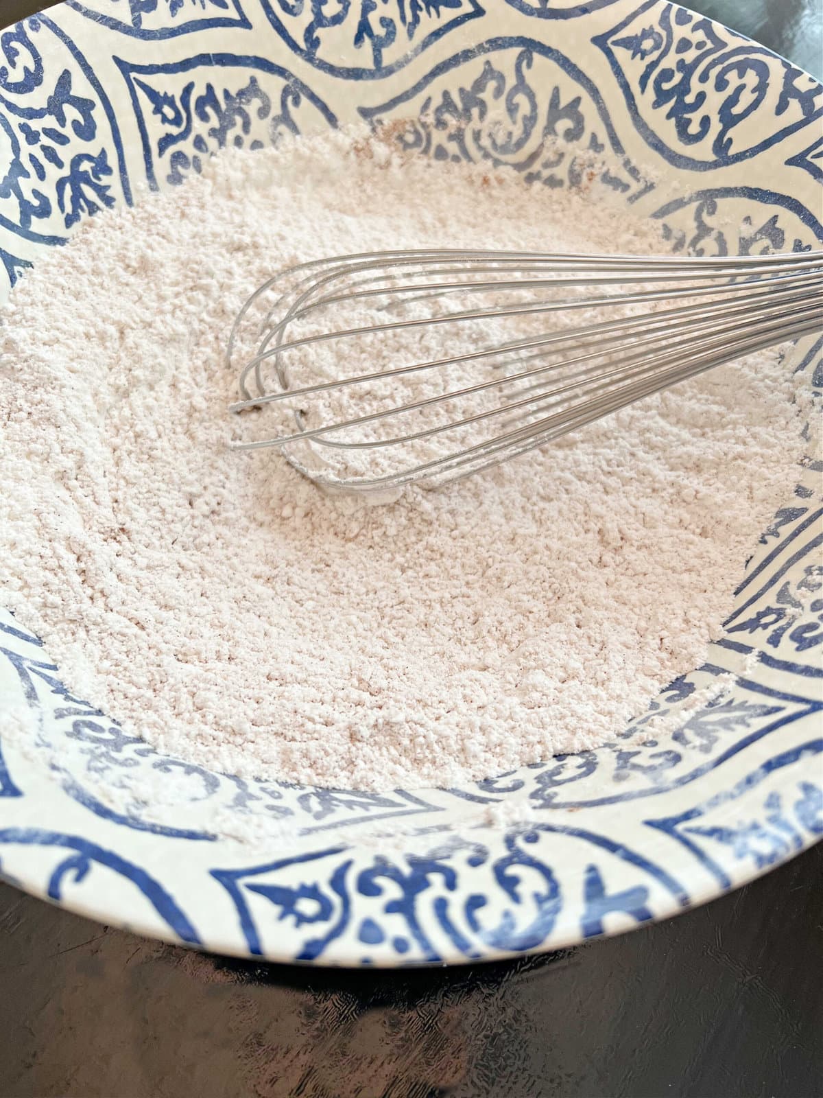 Dry ingredients in a mixing bowl with whisk.