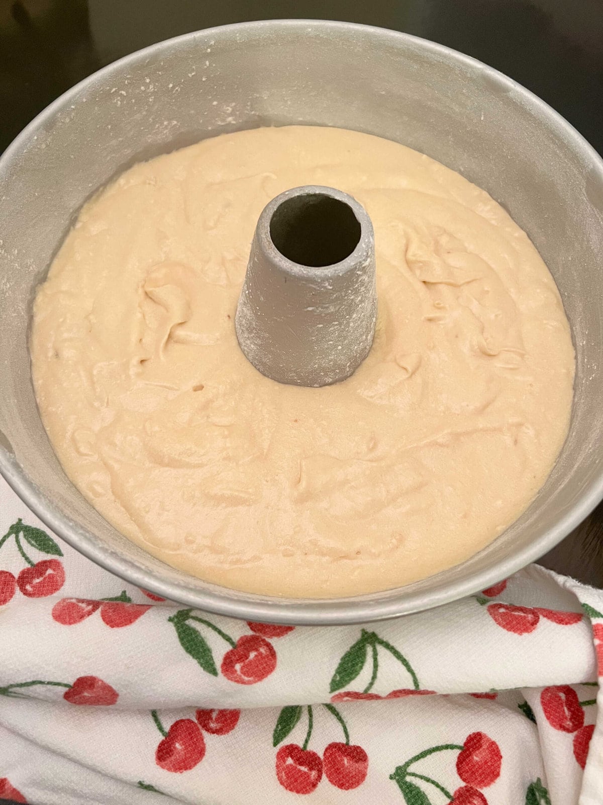 Tube pan filled with maple pound cake batter.