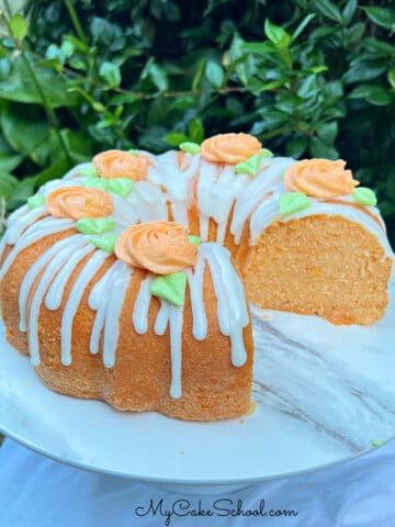 Sliced Orange Bundt Cake on cake pedestal.