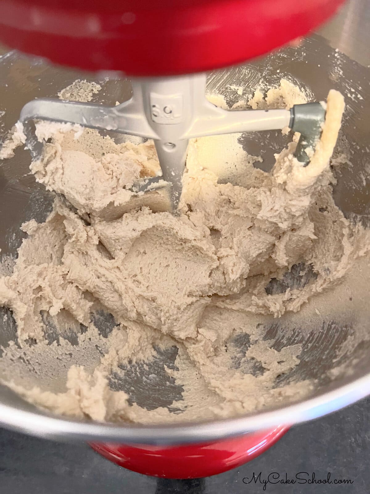 Mixture of butter and sugar in mixing bowl.