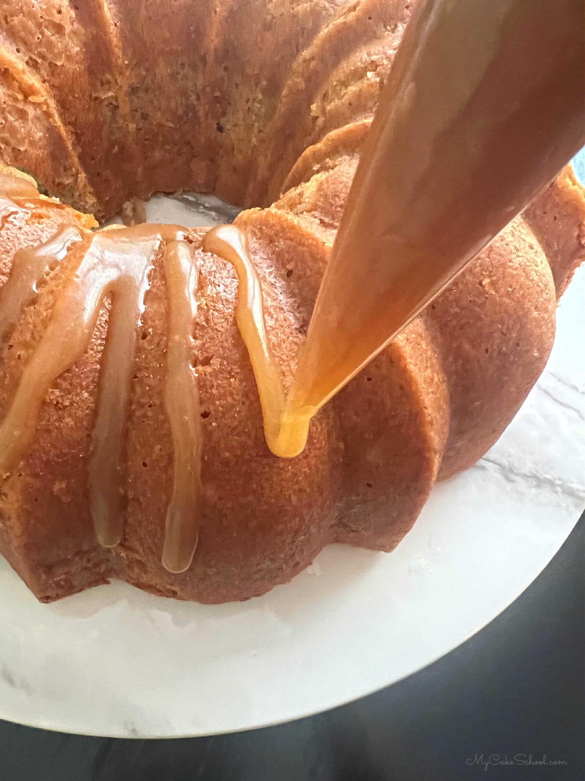 Applying caramel glaze to the banana pound cake.