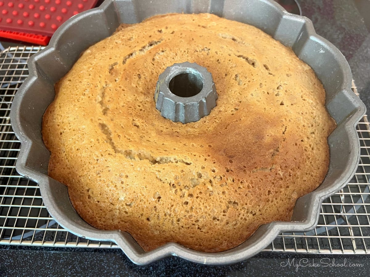 Banana Pound Cake cooling in pan on a cooling rack.