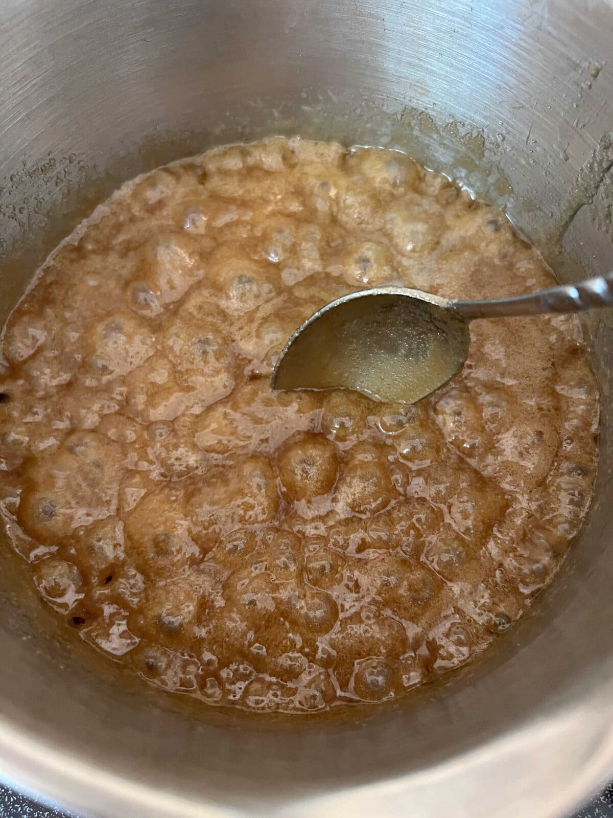 Saucepan of boiling caramel sauce.