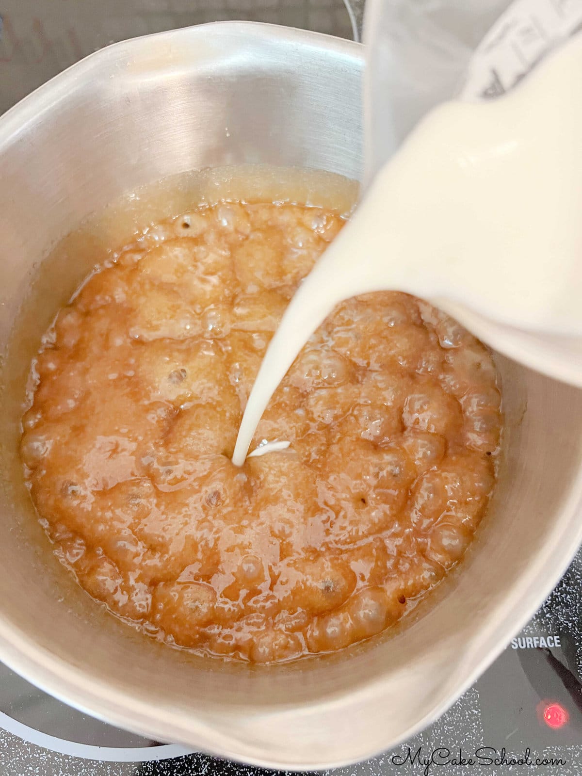 Pouring cream into saucepan of boiling caramel sauce.