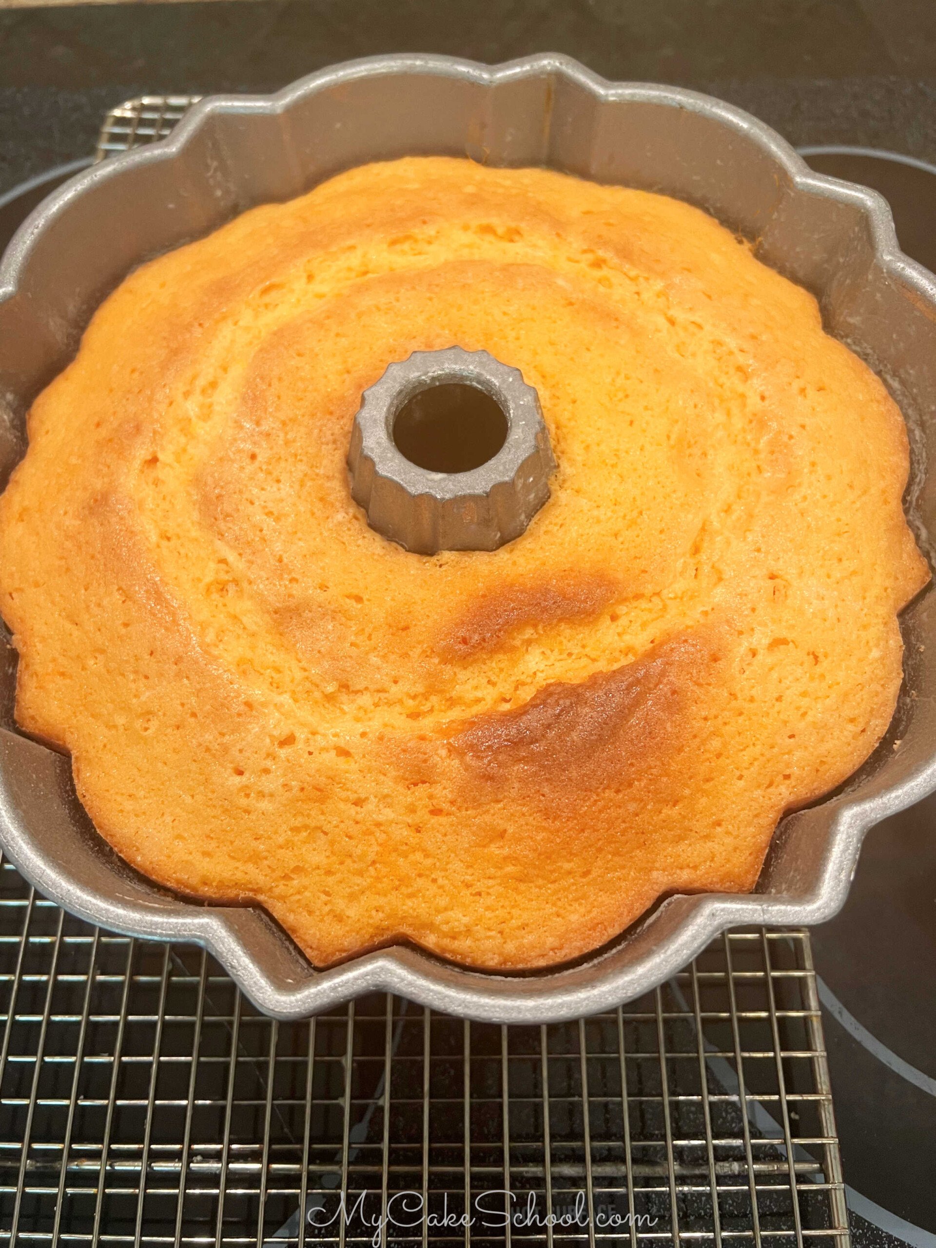 Freshly baked Orange Bundt Cake, cooling on wire rack.