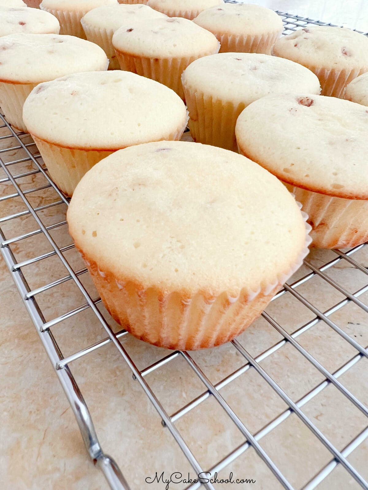 Snickerdoodle Cupcakes, freshly baked and on a cooling rack.