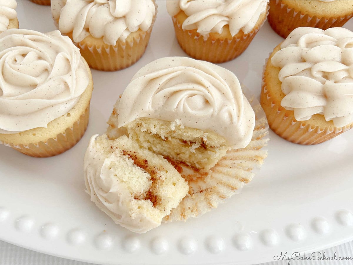 Sliced snickerdoodle cupcake, revealing the cinnamon and brown sugar swirl.