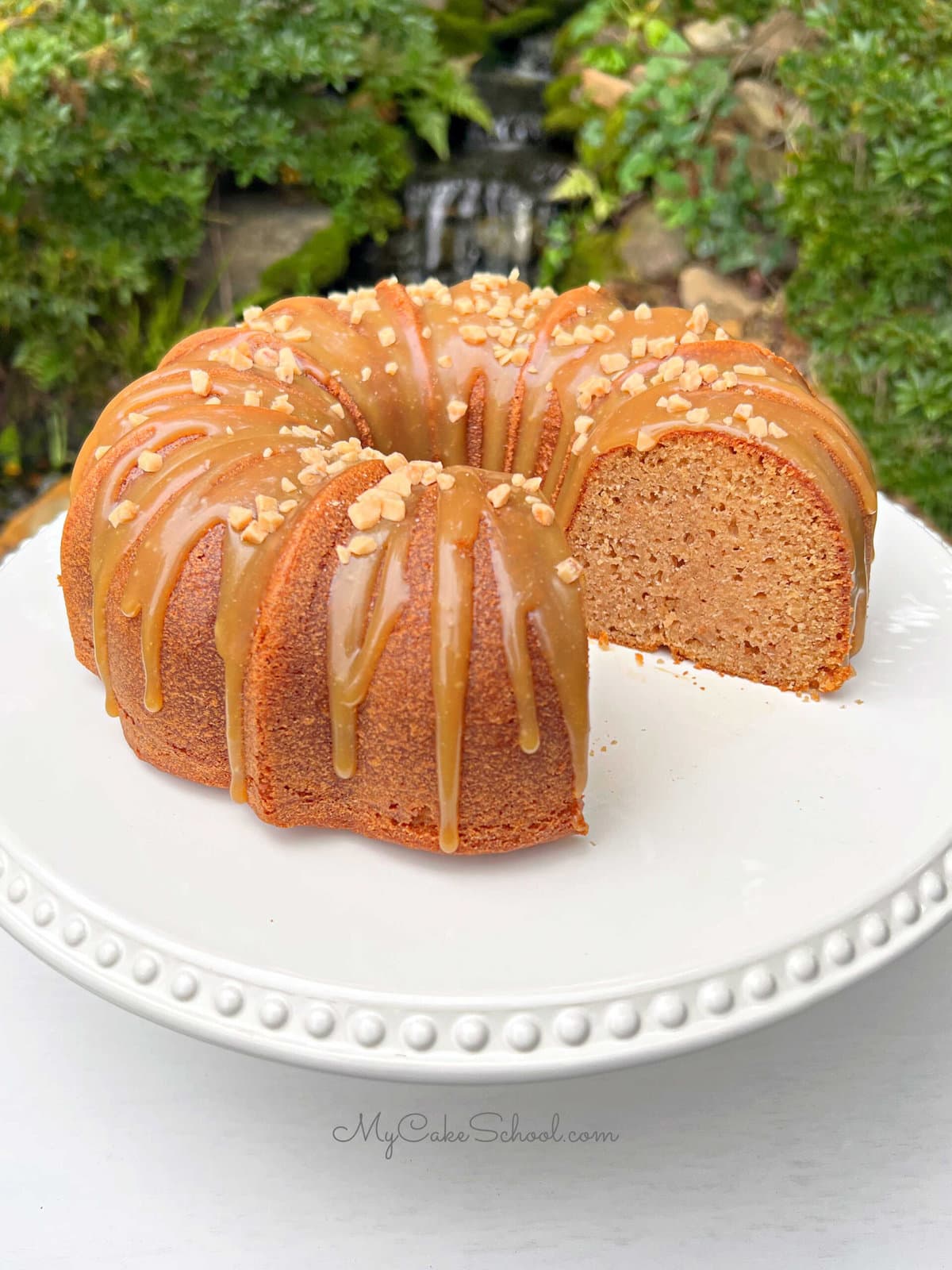 Applesauce Cake, sliced, on a pedestal.