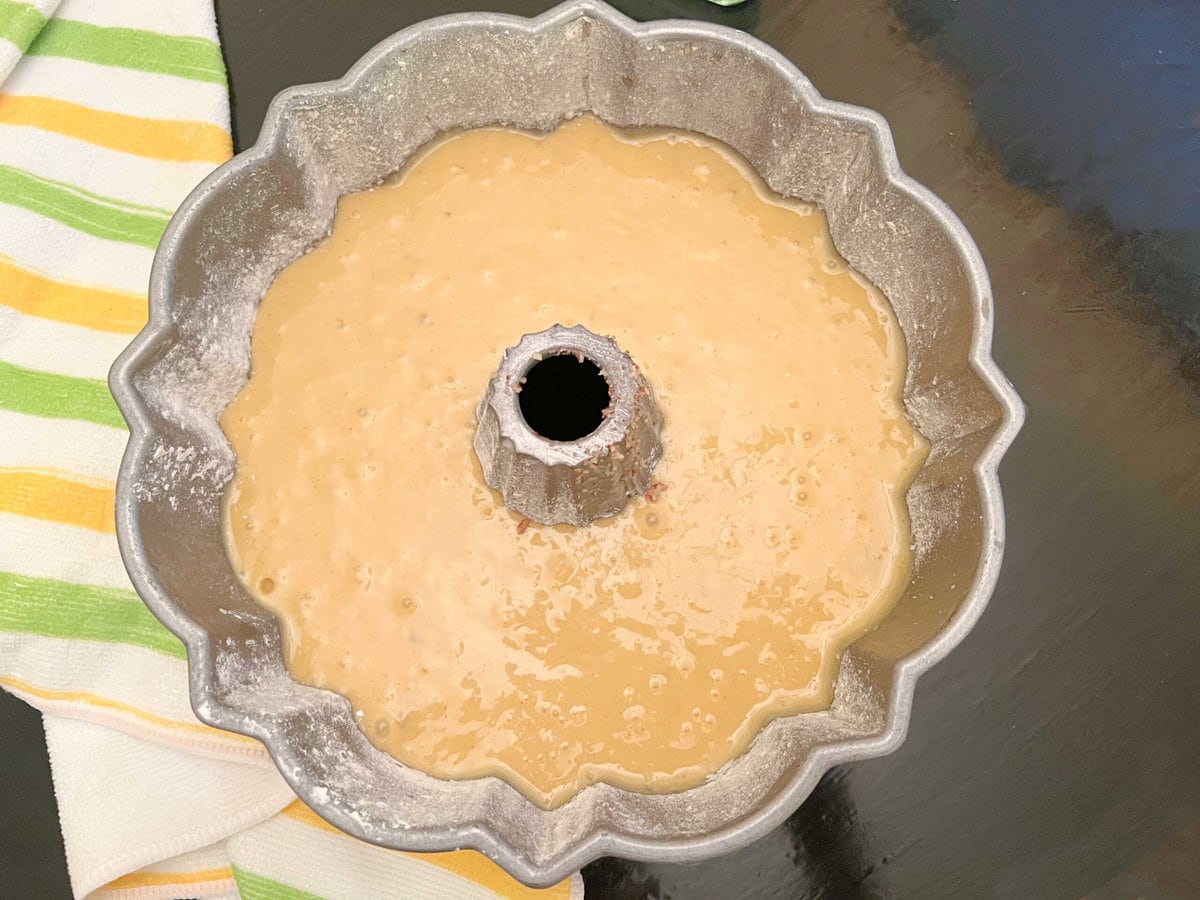 Prepared bundt pan filled with cake batter.