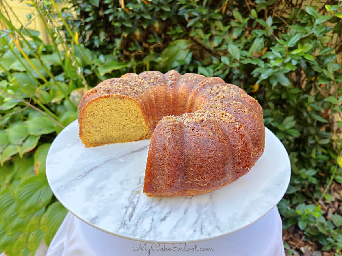 Banana Rum Cake, sliced, on cake pedestal.