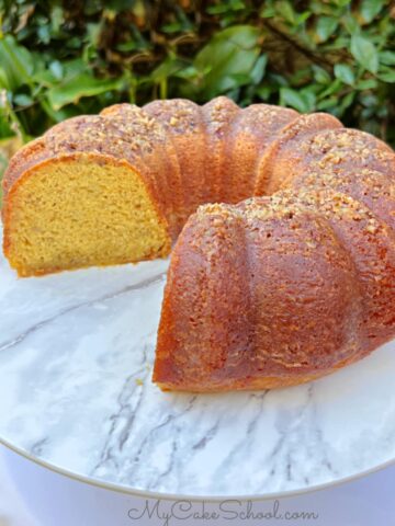 Banana Rum Cake, sliced, on a cake pedestal.