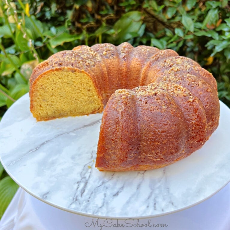 Banana Rum Cake, sliced, on a cake pedestal.